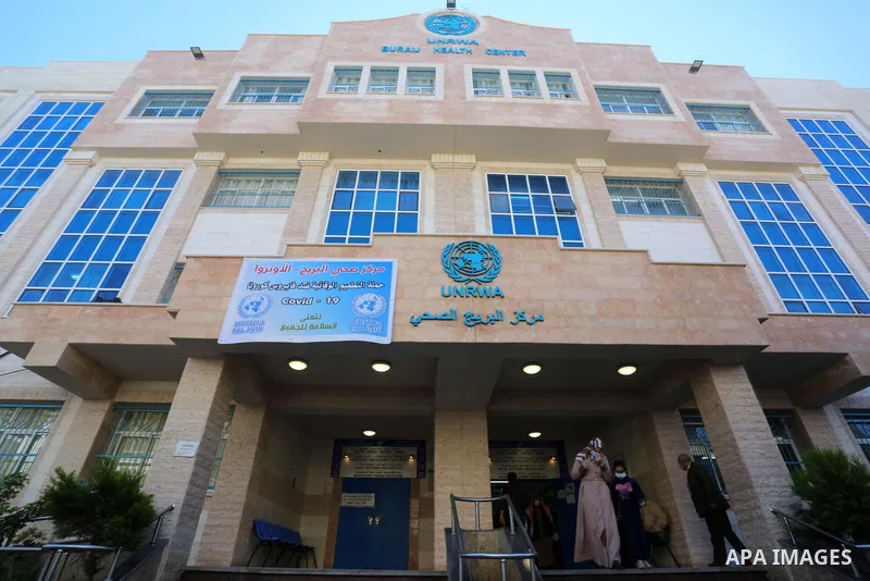 UNRWA employees wear face masks as the provide services in a UN clinic, in Al-Bureij camp in the central Gaza Strip, on March 6, 2021. UNRWA said that this year, the Agency will support approximately 1.25 million food-in...