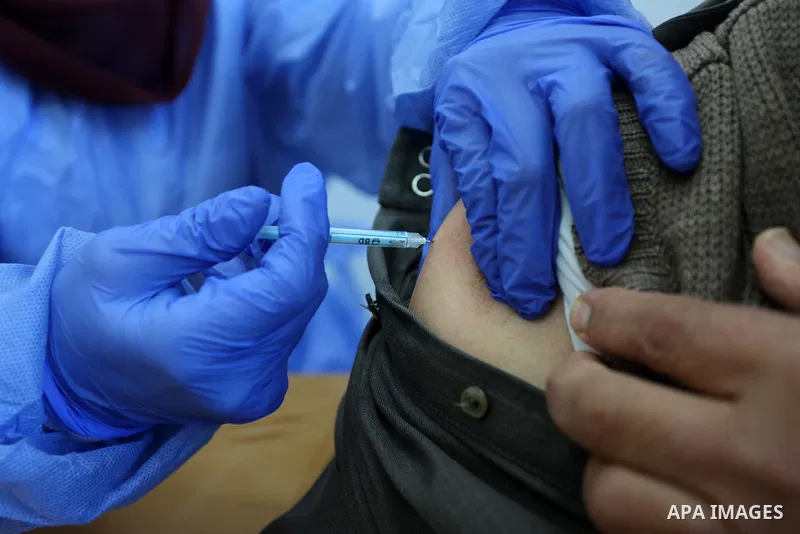 An employee of the United Nations Relief and Works Agency for Palestine Refugees (UNRWA) administers a shot of the Sputnik V COVID-19 vaccine at the UNRWA clininc in Al-Bureij camp in the central Gaza Strip, on March 6,...