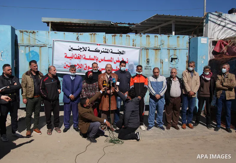 Palestinian refugees take part in a protest in front of the aid distribution center run by the United Nations Relief and Works Agency (UNRWA), at Al-Shati refugee camp in Gaza City, on March 6, 2021. Closure of the aid d...