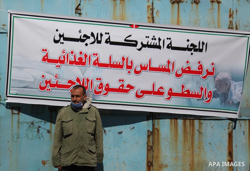 Palestinian refugees take part in a protest in front of the aid distribution center run by the United Nations Relief and Works Agency (UNRWA), at Al-Shati refugee camp in Gaza City, on March 6, 2021. Closure of the aid d...