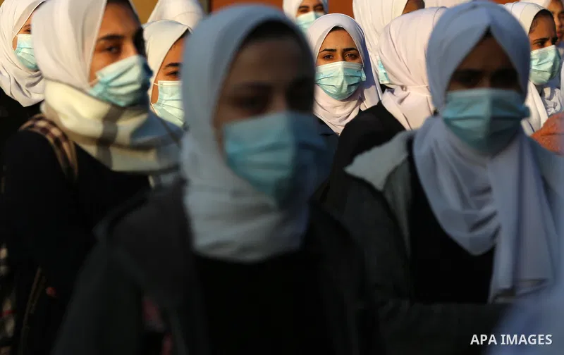 Palestinian students wearing protective face masks, return back to their school, in the morning of the first day of the second semester study, amid the coronavirus disease (COVID-19) outbreak, in Dair Al Balah in the cen...