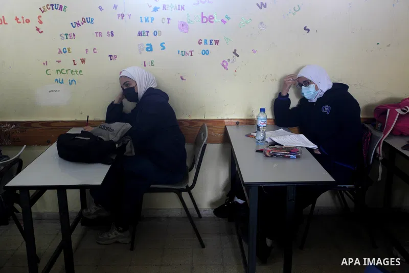 Palestinian students wearing protective face masks, sit in a classroom, in the morning of the first day of the second semester study, amid the coronavirus disease (COVID-19) outbreak, at their school, in Gaza city, on Fe...