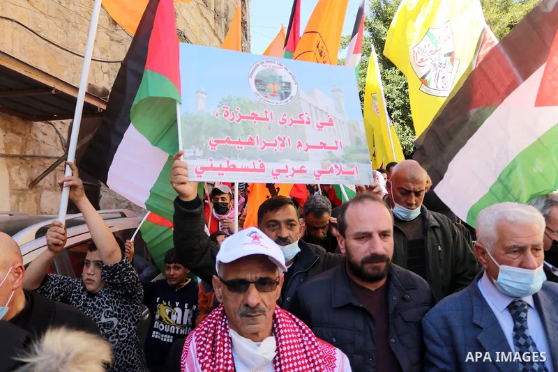 Palestinian protesters take part in a demonstration in memory of the 1994 Ibrahimi Mosque massacre, in which a Jewish extremist killed dozens of Palestinian worshippers, in the occupied West Bank city of Hebron on Februa...