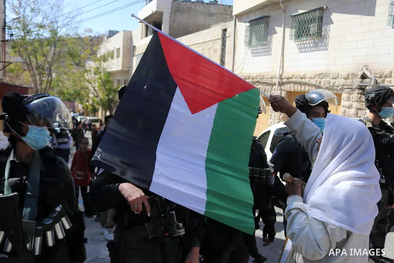 Israeli forces block Palestinian protesters during a demonstration in memory of the 1994 Ibrahimi Mosque massacre, in which a Jewish extremist killed dozens of Palestinian worshippers, in the occupied West Bank city of H...