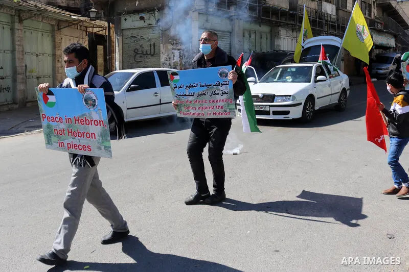 Palestinian protesters take part in a demonstration in memory of the 1994 Ibrahimi Mosque massacre, in which a Jewish extremist killed dozens of Palestinian worshippers, in the occupied West Bank city of Hebron on Februa...