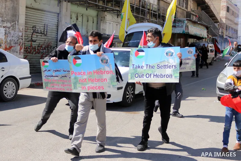 Palestinian protesters take part in a demonstration in memory of the 1994 Ibrahimi Mosque massacre, in which a Jewish extremist killed dozens of Palestinian worshippers, in the occupied West Bank city of Hebron on Februa...