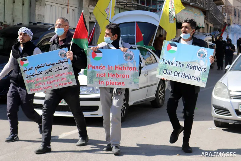 Palestinian protesters take part in a demonstration in memory of the 1994 Ibrahimi Mosque massacre, in which a Jewish extremist killed dozens of Palestinian worshippers, in the occupied West Bank city of Hebron on Februa...