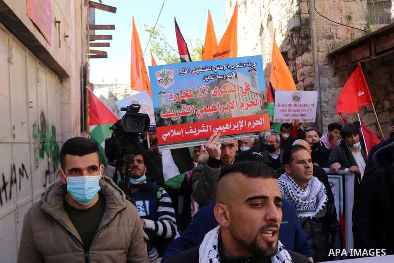 Palestinian protesters take part in a demonstration in memory of the 1994 Ibrahimi Mosque massacre, in which a Jewish extremist killed dozens of Palestinian worshippers, in the occupied West Bank city of Hebron on Februa...