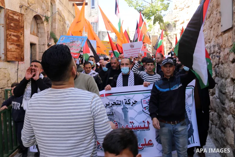 Palestinian protesters take part in a demonstration in memory of the 1994 Ibrahimi Mosque massacre, in which a Jewish extremist killed dozens of Palestinian worshippers, in the occupied West Bank city of Hebron on Februa...