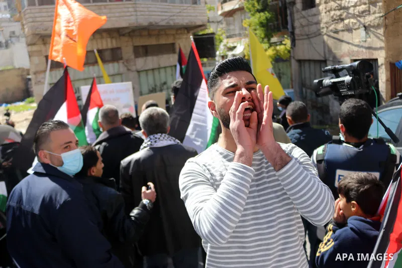 Palestinian protesters take part in a demonstration in memory of the 1994 Ibrahimi Mosque massacre, in which a Jewish extremist killed dozens of Palestinian worshippers, in the occupied West Bank city of Hebron on Februa...