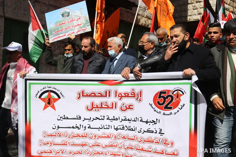 Palestinian protesters take part in a demonstration in memory of the 1994 Ibrahimi Mosque massacre, in which a Jewish extremist killed dozens of Palestinian worshippers, in the occupied West Bank city of Hebron on Februa...