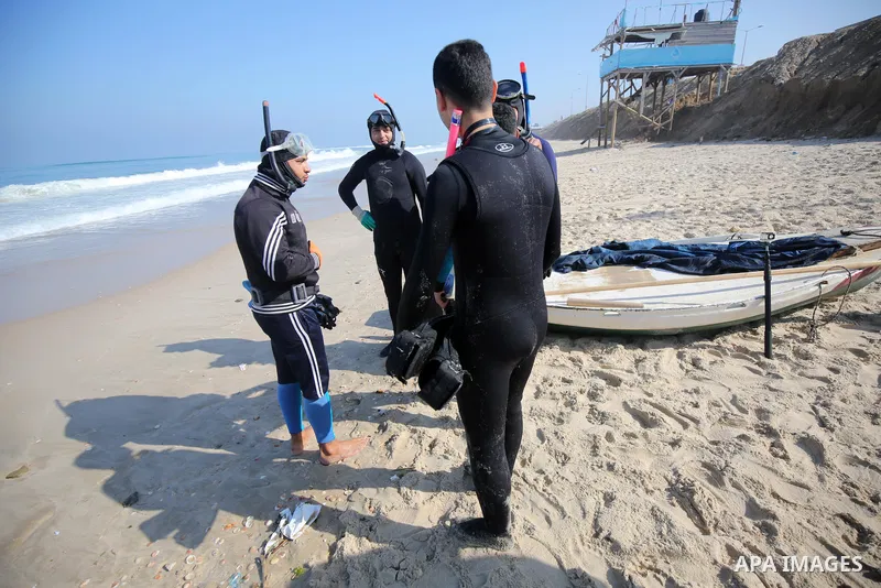 Palestinian divers take part in a volunteer campaign to search for the missing Egyptian sailors, in the sea of Gaza City on February 26, 2021. The Ministry of Interior in the Gaza Strip said that it found a body that was...