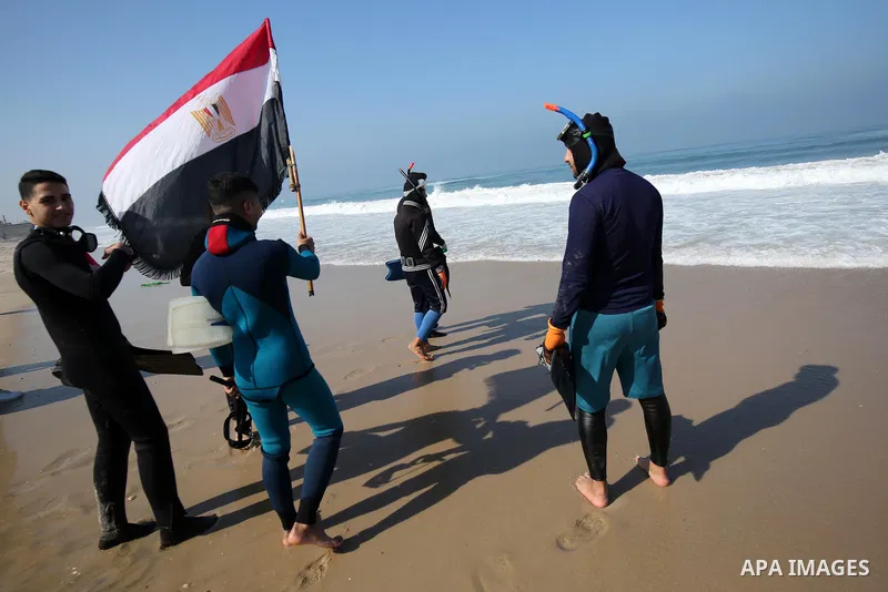 Palestinian divers take part in a volunteer campaign to search for the missing Egyptian sailors, in the sea of Gaza City on February 26, 2021. The Ministry of Interior in the Gaza Strip said that it found a body that was...