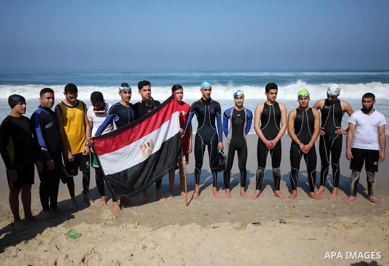 Palestinian divers take part in a volunteer campaign to search for the missing Egyptian sailors, in the sea of Gaza City on February 26, 2021. The Ministry of Interior in the Gaza Strip said that it found a body that was...