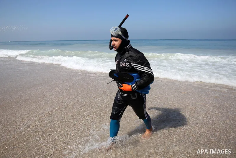 Palestinian divers take part in a volunteer campaign to search for the missing Egyptian sailors, in the sea of Gaza City on February 26, 2021. The Ministry of Interior in the Gaza Strip said that it found a body that was...