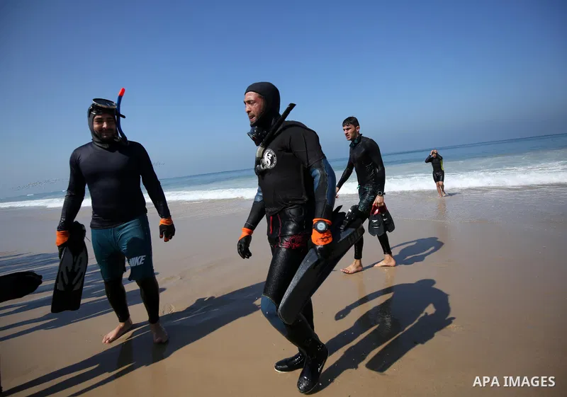 Palestinian divers take part in a volunteer campaign to search for the missing Egyptian sailors, in the sea of Gaza City on February 26, 2021. The Ministry of Interior in the Gaza Strip said that it found a body that was...