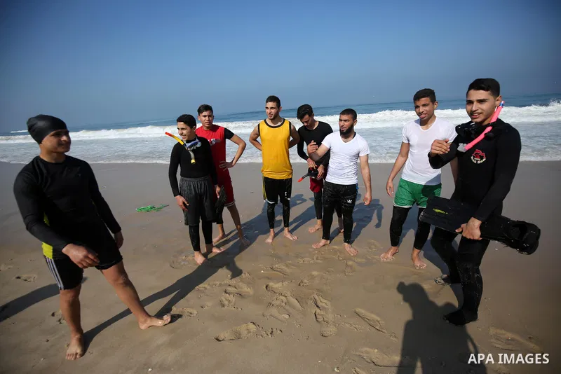 Palestinian divers take part in a volunteer campaign to search for the missing Egyptian sailors, in the sea of Gaza City on February 26, 2021. The Ministry of Interior in the Gaza Strip said that it found a body that was...