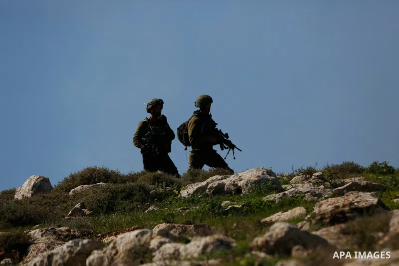 Israeli forces take position during a demonstration against the expansion of settlements, in Beit Dajan in the Israeli-occupied West Bank on February 26, 2021. The settler population in the West Bank has grown by around...