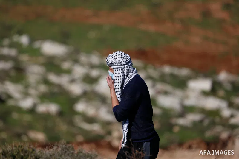 Palestinian protesters hurl a stones towards Israeli security forces during a demonstration against the expansion of settlements, in Beit Dajan in the Israeli-occupied West Bank on February 26, 2021. The settler populati...