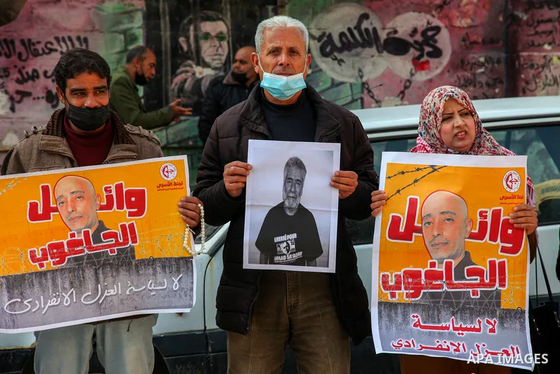 Palestinians take part in a protest to show solidarity with prisoners and the spread of the coronavirus disease (COVID-19) on Israeli Jails, in front of the headquarters of Red cross in Gaza city, on February 22, 2021. P...