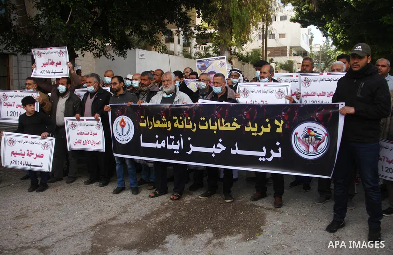 Families of Palestinian martyrs and wounded, take part in a protest against the Palestinian Authority's decision to cut their salaries for seven years, in Gaza city, on February 21, 2021. In January 2019, the PA cut the...