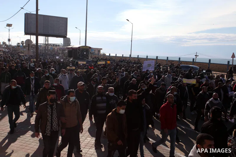 Palestinian employees of the security services -2005, take part in a march to demand an end to the issue of 2005 legally, in front of the headquarters of the Central Committee of Fatah, in Gaza city on February 20, 2021....