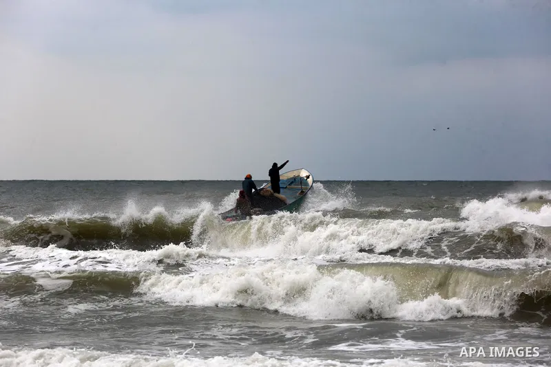 Palestinian fishermen work on their fishing boats in Deir al-Balah, in the central of Gaza Strip, on February 19, 2021. The bad weather and snow that hit Palestine yesterday led to the disruption of fishermen's work at s...