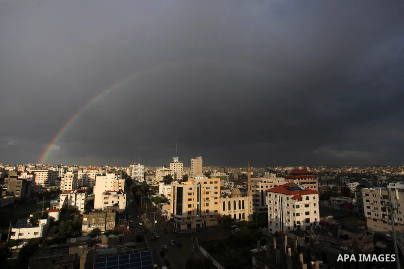 A rainbow appears above buildings following a rainstorm in Gaza City, on February 18, 2021. The bad weather and snow that hit Palestine yesterday and is expected to continue today caused damage to homes, mainly in the Ga...