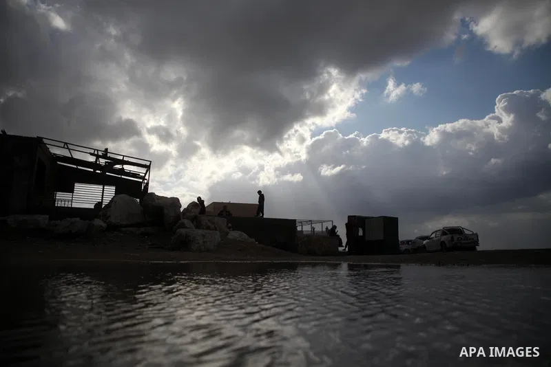 Palestians enjoy during a rainy day, at a beach in Gaza City, on February 18, 2021. The bad weather and snow that hit Palestine yesterday and is expected to continue today caused damage to homes, mainly in the Gaza Strip...