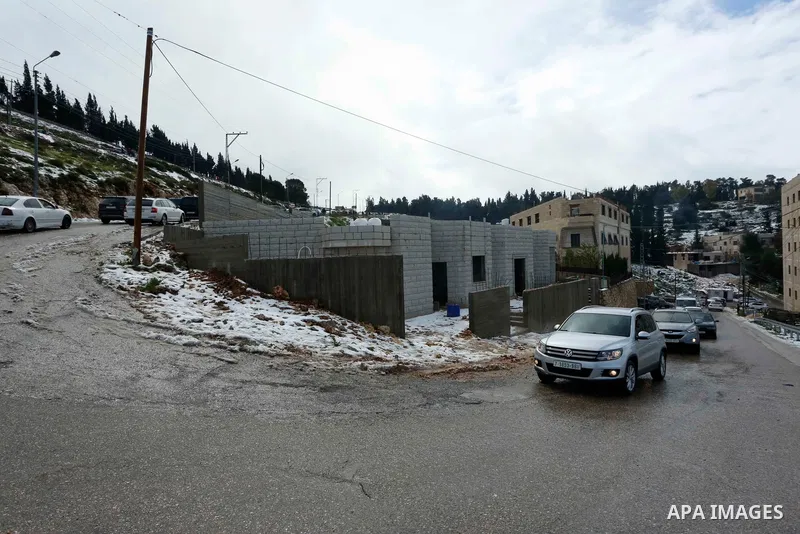 Palestinians enjoy the snow during a snow storm, in the West Bank city of Nablus on February 18, 2021.The bad weather and snow that hit Palestine yesterday and is expected to continue today caused damage to homes, mainly...