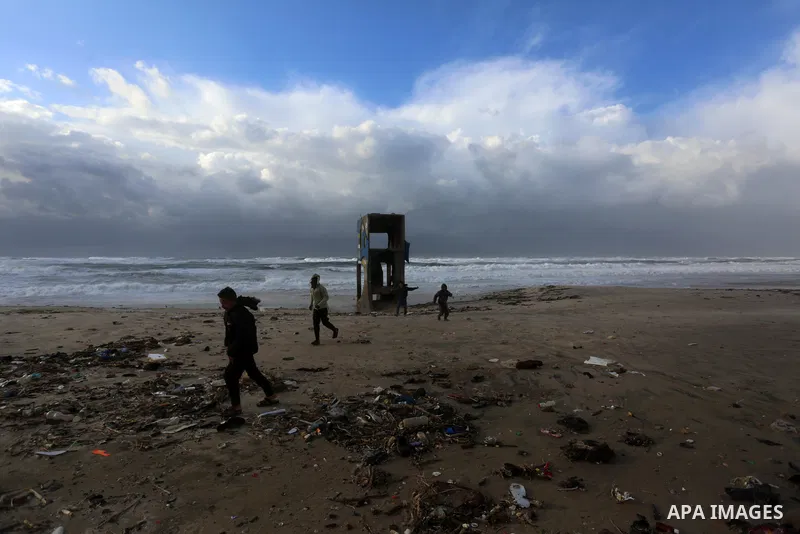 Palestians enjoy during a stormy day, at a beach in Deir El-Balah, in the center of the Gaza Strip, on February 17, 2021. The cloudy, stormy and very cold conditions are expected to continue on Thursday. Scattered torren...