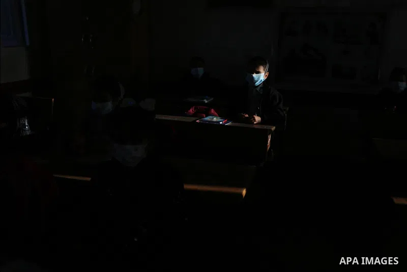 Palestinian students wearing protective face masks, as schools gradually reopen amid the coronavirus disease (COVID-19) outbreak, at their school run by the United Nations Relief and Works Agency (UNRWA) in Deir al-Balah...