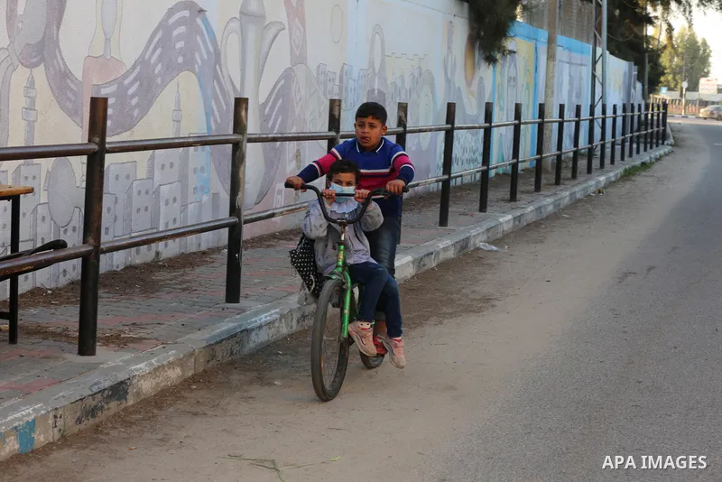 Palestinian students wearing protective face masks, as schools gradually reopen amid the coronavirus disease (COVID-19) outbreak, at their school run by the United Nations Relief and Works Agency (UNRWA) in Deir al-Balah...