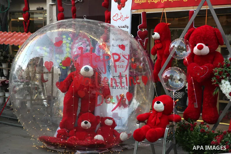 Palestinian vendors display flowers, red teddy bears, and pillows on Valentine's day, in Gaza city on February 13, 2021. Valentine's Day is increasingly popular in the region as people have taken up the custom of giving...