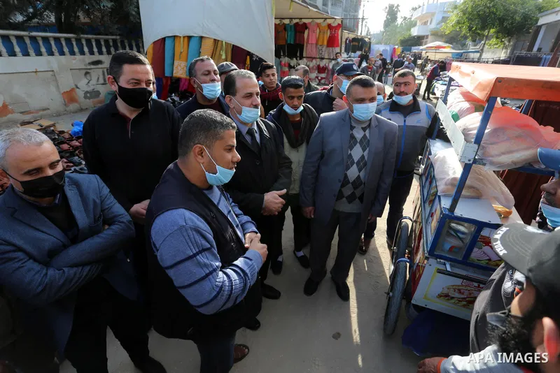 Palestinian Ahmed Abu Ras, Undersecretary of the Ministry of Local Government, takes part in an inspection tour of a popular market after lifting the state of closure, in Deir El-Balah, in the center of the Gaza Strip, o...