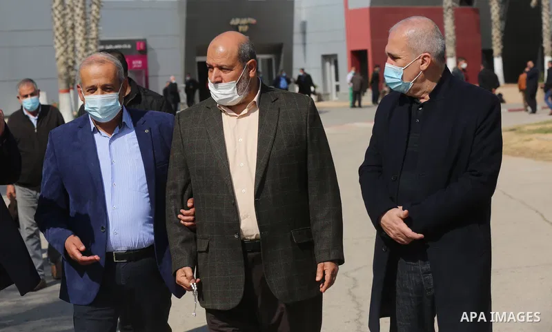 Members of the Palestinian factions are wait to cross into Egypt through the Rafah border crossing, in Rafah in the southern of Gaza Strip, on February 7, 2021. On Sunday, delegations belonging to different Palestinian f...