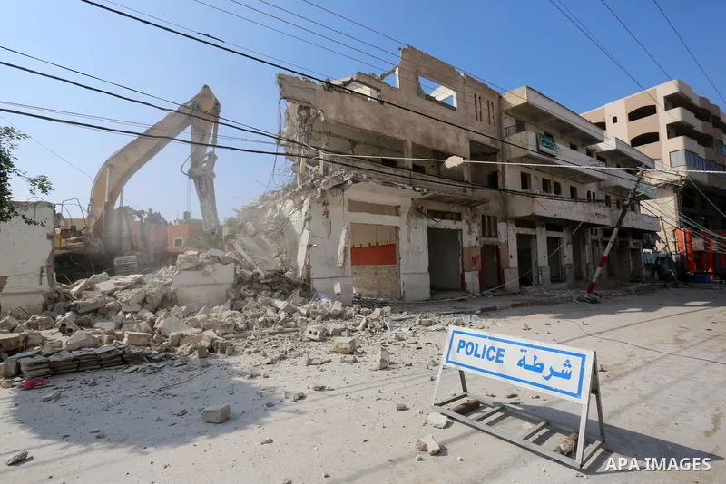 Palestinian workers demolish the old municipality building of Deir Al-Balah to develop the place in Deir Al-Balah in the central Gaza Strip, on February 6, 2021. Gaza suffered shortages of water, medicine and power, a si...