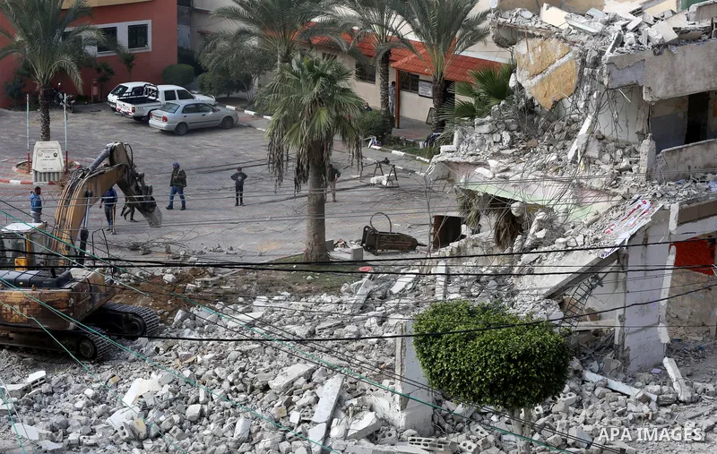 Palestinian workers demolish the old municipality building of Deir Al-Balah to develop the place in Deir Al-Balah in the central Gaza Strip, on February 6, 2021. Gaza suffered shortages of water, medicine and power, a si...