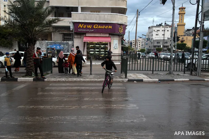 Palestinians walk on the street in Gaza City on February 4, 2021. After the decision to ease the preventive measures taken by lifting the ban and daily night closings starting from today, Thursday, February 4, 2021, and...