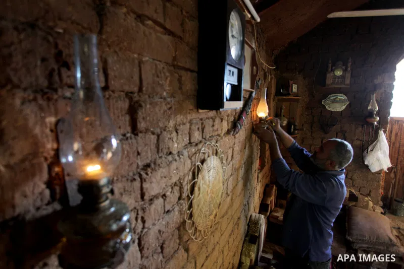 A Palestinian man arranges old furniture and collectibles in his mud house in Gaza City on February 3, 2021. The rich archaeological and architectural heritage of Palestine has suffered from alarming destruction, deterio...
