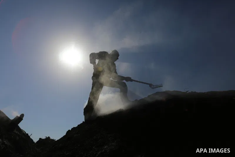 Palestinian charcoal worker Taha Al-Hattab, 60, works at his production facility near the border, east of Gaza City, on February 3, 2021. Al-Hattab charcoal-making facility is the largest producer in the Gaza Strip. Eigh...