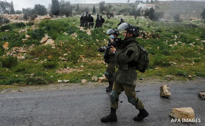 Israeli security forces take position during clashes with Palestinian protesters following a weekly demonstration against the expropriation of Palestinian land by Israel in the village of Kfar Qaddum, near the West Bank...