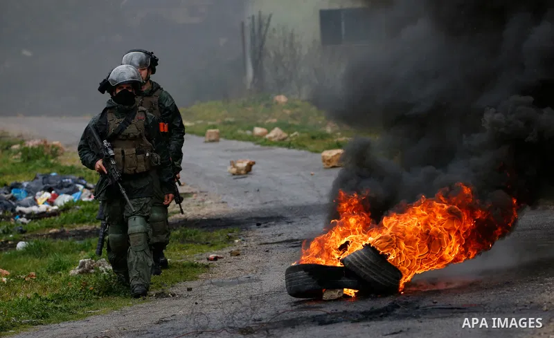 Israeli security forces take position during clashes with Palestinian protesters following a weekly demonstration against the expropriation of Palestinian land by Israel in the village of Kfar Qaddum, near the West Bank...
