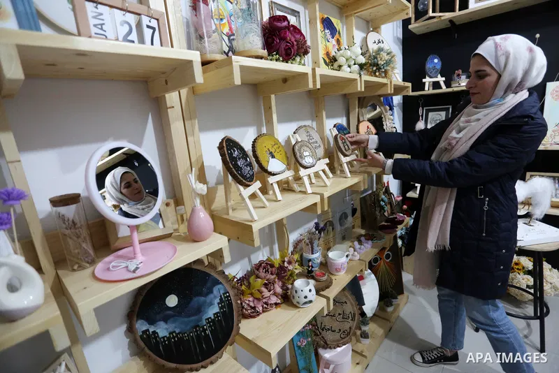 Two Palestinian graduates Haya Abu Daqqa and Areej Al-Saqa work in a gift and antiques store, in Khan Yunis in the southern Gaza Strip on January 28, 2021. Unemployment rate in the Gaza Strip is still among the highest i...