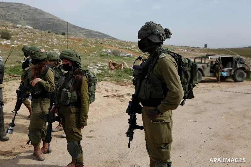 Israeli border police take position during clashes with Palestinian protesters near Tubas in the West Bank January 27, 2021. Today, Wednesday, the Israeli occupation forces uprooted hundreds of forest trees, with ages ra...