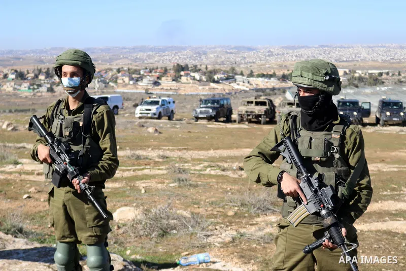 Foreign activists argue with Israeli soldiers during a protest against the Israeli army and settler attacks targeting the area’s Palestinian residents, in Yatta village in the southern West bank City of Hebron on January...