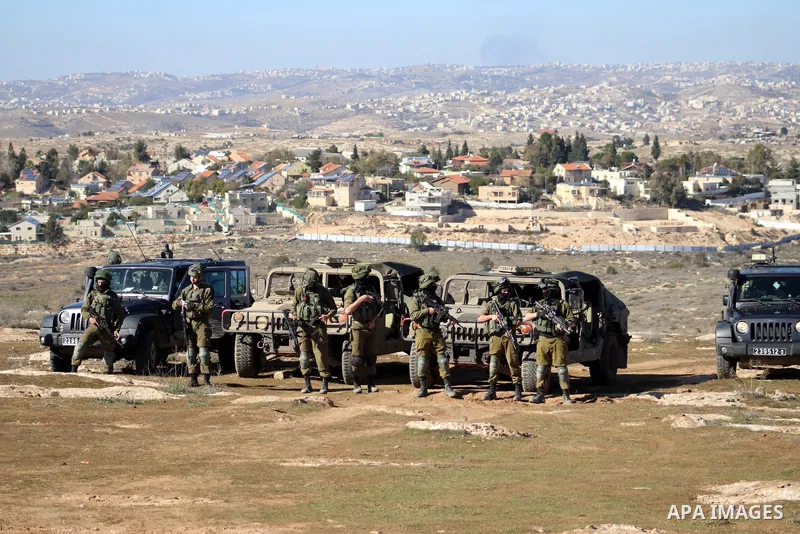 Foreign activists argue with Israeli soldiers during a protest against the Israeli army and settler attacks targeting the area’s Palestinian residents, in Yatta village in the southern West bank City of Hebron on January...