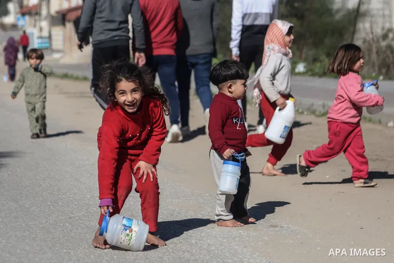 Palestinian children play in the street after the coronavirus disease (COVID-19) restrictions eased, in Gaza City, on January 23, 2021. The Ministry of Interior announced a series of measures to alleviate the restriction...