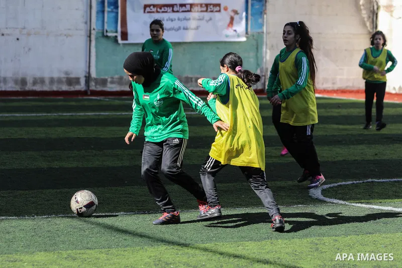 Palestinian girls take part in a local football competition in Gaza City January 21, 2021. Women's association football, usually known as women's football or women's soccer, and colloquially WOSO, is the team sport of as...