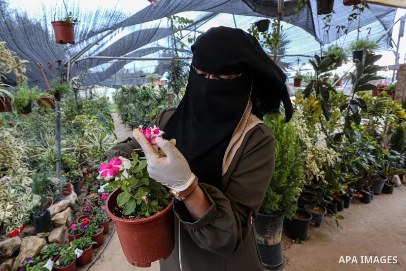 Palestinian woman Hanin Abu Salah, 26, works with her husband in a plant nursery, in Khan Yunis in the southern Gaza Strip on January 19, 2021. The rate of participation in the workforce in Gaza during the second quarter...